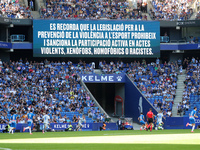 A warning on the scoreboard advises against chanting racist, homophobic, or xenophobic insults or engaging in violent actions in the stands...