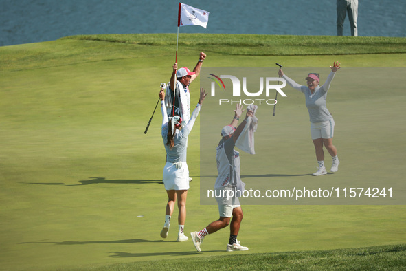 GAINESVILLE, VIRGINIA - SEPTEMBER 14: Megan Khang of the United States celebrates her putt on the 11th with teammates during Fourball Matche...