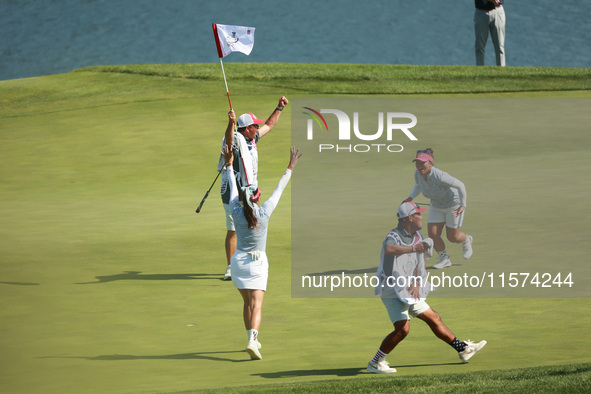 GAINESVILLE, VIRGINIA - SEPTEMBER 14: Megan Khang of the United States celebrates her putt on the 11th with teammates during Fourball Matche...