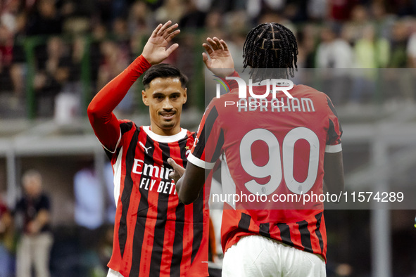 Tammy Abraham and Tijjani Reijnders are in action during the Serie A match between AC Milan and Venezia FC in Milano, Italy, on September 14...