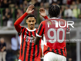 Tammy Abraham and Tijjani Reijnders are in action during the Serie A match between AC Milan and Venezia FC in Milano, Italy, on September 14...