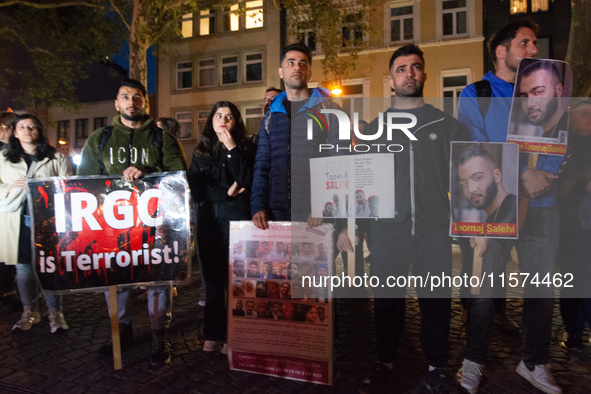 Nearly a hundred Iranian activists take part in a candlelight vigil for the second anniversary of Mahsa Amini's death in Cologne, Germany, o...