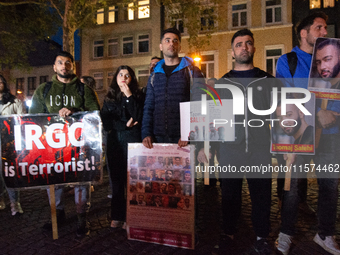 Nearly a hundred Iranian activists take part in a candlelight vigil for the second anniversary of Mahsa Amini's death in Cologne, Germany, o...