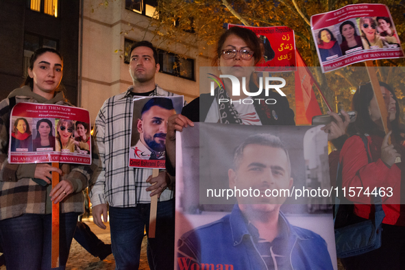 Nearly a hundred Iranian activists take part in a candlelight vigil for the second anniversary of Mahsa Amini's death in Cologne, Germany, o...