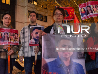 Nearly a hundred Iranian activists take part in a candlelight vigil for the second anniversary of Mahsa Amini's death in Cologne, Germany, o...