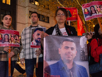 Nearly a hundred Iranian activists take part in a candlelight vigil for the second anniversary of Mahsa Amini's death in Cologne, Germany, o...