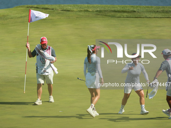 GAINESVILLE, VIRGINIA - SEPTEMBER 14: Megan Khang of the United States celebrates with her teammates after her putt on the 11th green during...