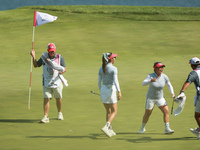 GAINESVILLE, VIRGINIA - SEPTEMBER 14: Megan Khang of the United States celebrates with her teammates after her putt on the 11th green during...