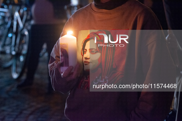 Nearly a hundred Iranian activists take part in a candlelight vigil for the second anniversary of Mahsa Amini's death in Cologne, Germany, o...