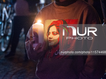 Nearly a hundred Iranian activists take part in a candlelight vigil for the second anniversary of Mahsa Amini's death in Cologne, Germany, o...