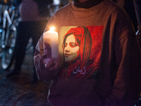 Nearly a hundred Iranian activists take part in a candlelight vigil for the second anniversary of Mahsa Amini's death in Cologne, Germany, o...