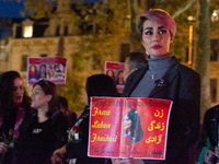 Nearly a hundred Iranian activists take part in a candlelight vigil for the second anniversary of Mahsa Amini's death in Cologne, Germany, o...