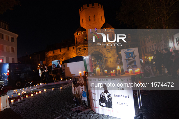 Nearly a hundred Iranian activists take part in a candlelight vigil for the second anniversary of Mahsa Amini's death in Cologne, Germany, o...