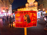 Nearly a hundred Iranian activists take part in a candlelight vigil for the second anniversary of Mahsa Amini's death in Cologne, Germany, o...