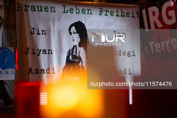 Nearly a hundred Iranian activists take part in a candlelight vigil for the second anniversary of Mahsa Amini's death in Cologne, Germany, o...