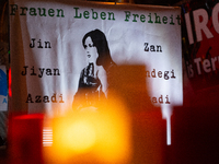 Nearly a hundred Iranian activists take part in a candlelight vigil for the second anniversary of Mahsa Amini's death in Cologne, Germany, o...