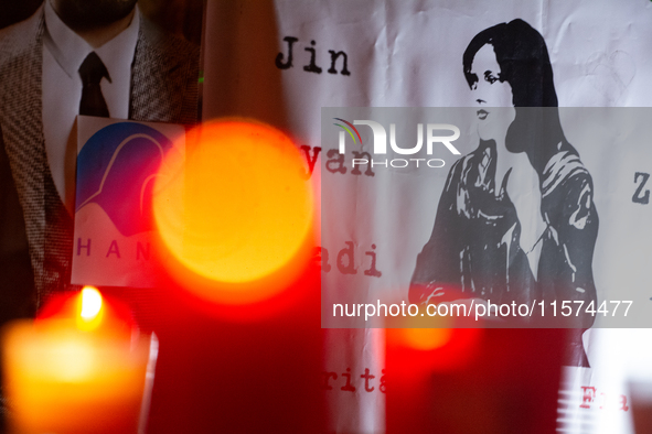 Nearly a hundred Iranian activists take part in a candlelight vigil for the second anniversary of Mahsa Amini's death in Cologne, Germany, o...