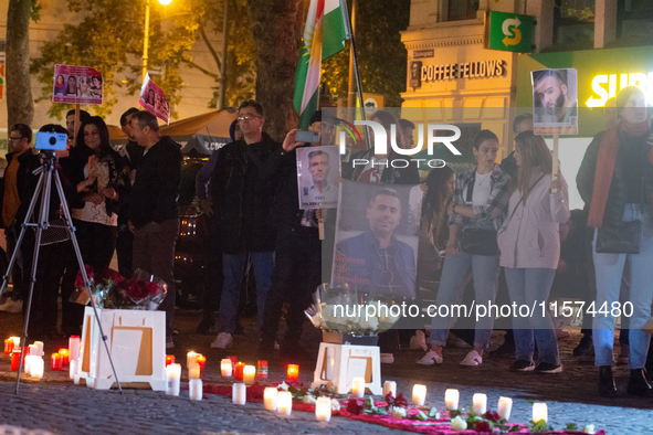 Nearly a hundred Iranian activists take part in a candlelight vigil for the second anniversary of Mahsa Amini's death in Cologne, Germany, o...