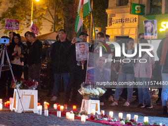 Nearly a hundred Iranian activists take part in a candlelight vigil for the second anniversary of Mahsa Amini's death in Cologne, Germany, o...