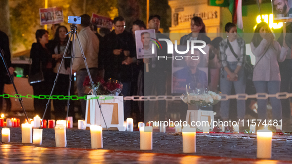 Nearly a hundred Iranian activists take part in a candlelight vigil for the second anniversary of Mahsa Amini's death in Cologne, Germany, o...