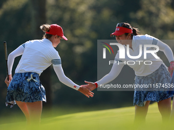 GAINESVILLE, VIRGINIA - SEPTEMBER 14: Sarah Schmelzel of the United States (L) celebrates her putt on the 11th green with teammate Lilia Vu...