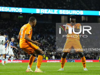 Kylian Mbappe centre-forward of Real Madrid and France celebrates with Vinicius Junior left winger of Real Madrid and Brazil after scoring h...