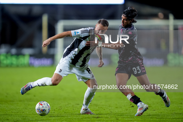 Youssef Maleh of Empoli FC and Teun Koopmeiners of Juventus FC compete for the ball during the Serie A Enilive match between Empoli FC and J...