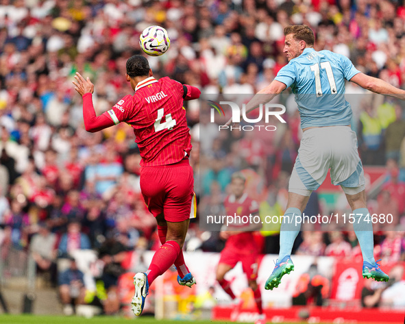 Chris Wood of Nottingham Forest challenges for a header with Liverpool's Virgil van Dijk during the Premier League match between Liverpool a...