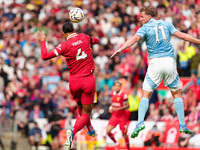 Chris Wood of Nottingham Forest challenges for a header with Liverpool's Virgil van Dijk during the Premier League match between Liverpool a...