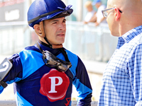 Jockey Eswan Flores speaks to a race connection after the fourth race at Woodbine Racetrack in Toronto, Canada, on September 14, 2024. (