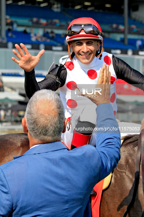 Jockey Rafael Hernandez receives a congratulatory handshake after riding And One More Time (7) to a win in the Johnnie Walker Natalma Stakes...