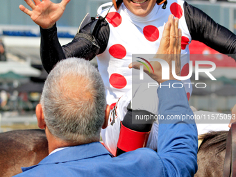 Jockey Rafael Hernandez receives a congratulatory handshake after riding And One More Time (7) to a win in the Johnnie Walker Natalma Stakes...