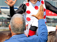 Jockey Rafael Hernandez receives a congratulatory handshake after riding And One More Time (7) to a win in the Johnnie Walker Natalma Stakes...