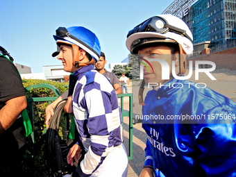 Jockeys Rafael Hernandez, left, and Umberto Rispoli arrive at the walking ring ahead of the bet365 Summer Stakes (Grade I) at Woodbine Racet...