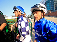 Jockeys Rafael Hernandez, left, and Umberto Rispoli arrive at the walking ring ahead of the bet365 Summer Stakes (Grade I) at Woodbine Racet...