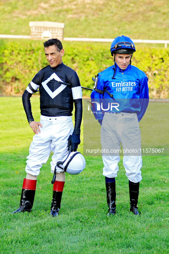 Jockeys John Velazquez, left, and William Buick wait for their mounts in the walking ring ahead of the bet365 Summer Stakes (Grade I) at Woo...