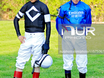 Jockeys John Velazquez, left, and William Buick wait for their mounts in the walking ring ahead of the bet365 Summer Stakes (Grade I) at Woo...