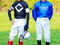 Jockeys John Velazquez, left, and William Buick wait for their mounts in the walking ring ahead of the bet365 Summer Stakes (Grade I) at Woo...