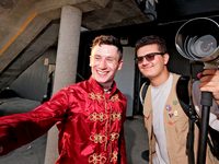 Jockey Oisin Murphy helps a race fan take a photograph after a win in the bet365 Summer Stakes (Grade I) at Woodbine Racetrack in Toronto, C...