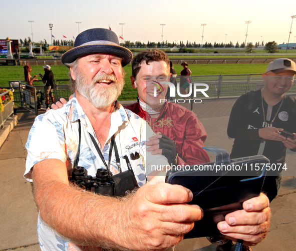 Jockey Oisin Murphy, right, is photographed by a race fan after a win in the bet365 Summer Stakes (Grade I) at Woodbine Racetrack in Toronto...