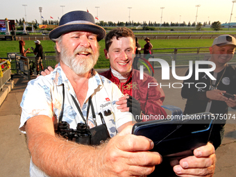 Jockey Oisin Murphy, right, is photographed by a race fan after a win in the bet365 Summer Stakes (Grade I) at Woodbine Racetrack in Toronto...