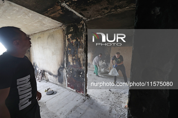 Construction workers restore a multi-storey residential building damaged by Russian shelling in Kharkiv, Ukraine, on September 12, 2024. NO...