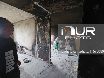 Construction workers restore a multi-storey residential building damaged by Russian shelling in Kharkiv, Ukraine, on September 12, 2024. NO...