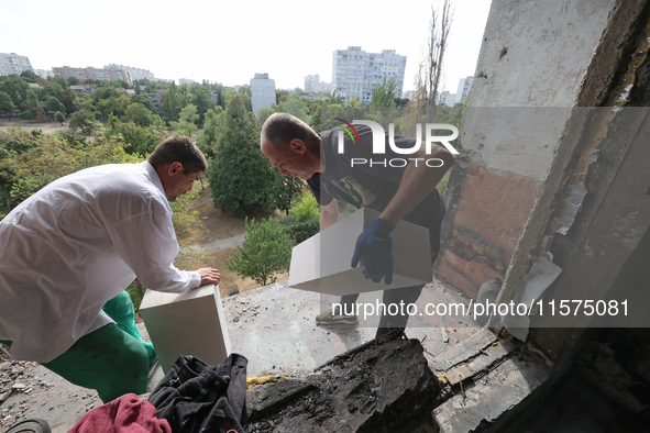 Construction workers restore a multi-storey residential building damaged by Russian shelling in Kharkiv, Ukraine, on September 12, 2024. NO...