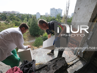 Construction workers restore a multi-storey residential building damaged by Russian shelling in Kharkiv, Ukraine, on September 12, 2024. NO...