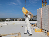 A construction worker restores a multi-storey residential building damaged by Russian shelling in Kharkiv, Ukraine, on September 12, 2024. N...