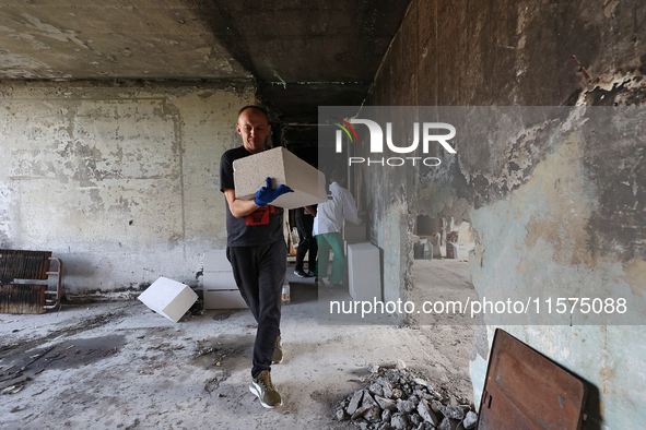 Construction workers restore a multi-storey residential building damaged by Russian shelling in Kharkiv, Ukraine, on September 12, 2024. NO...