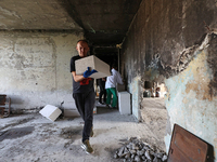 Construction workers restore a multi-storey residential building damaged by Russian shelling in Kharkiv, Ukraine, on September 12, 2024. NO...