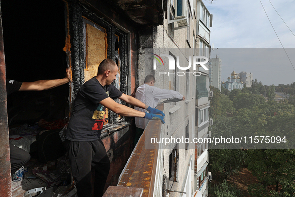 Construction workers restore a multi-storey residential building damaged by Russian shelling in Kharkiv, Ukraine, on September 12, 2024. NO...