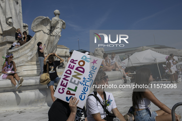 A person holds a sign with the text ''Gender Splendor for Everyone'' during the first gender liberation march at Union Station in Washington...